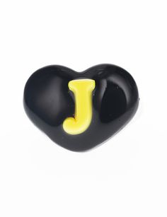 a black and yellow heart shaped object with the letter j on it's side