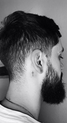 a man with a cross tattoo on his neck