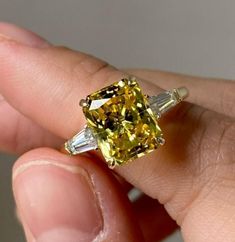 a fancy yellow diamond ring with baguettes