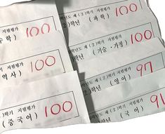 four pieces of white paper with red numbers on them and some words written in korean