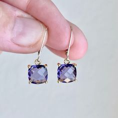 Amethyst Earrings, February Birthstone, Dark Purple Amethyst Cushion Cut Earrings in Gold or Silver, Square prong set Drops, Gift for her These elegant square earrings feature purple amethyst cushion cut gemstones prong set in your choice of gold filled or sterling silver. The faceted square Amethyst drops are suspended from lever back ear wires in the finish of your choice. These are great choice for simple yet elegant earrings to wear virtually anywhere. Ideal gift for a woman born in February Healing Naturally, Cushion Cut Earrings, Amethyst Properties, Amethyst Birthstone, Born In February, Silver Gift Wrap, Cut Earrings, Earrings Gemstone, Earrings In Gold