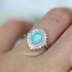 Victoria Neon Paraiba Tourmaline Ring ►Made of Sterling Silver, Rhodium Plated (S925) ►Accented with Simulated Diamonds (CZ) Center Stone: Paraiba Tourmaline Gemstone Creation: Lab-Created Stone Cut: Oval Color: Turquoise Gem size: 7.0 x 5.0 mm Carat Weight: 0.76 ct. Gemstone Origin: Brazil ►Handling time: 1-2 business days ►Free domestic USA shipping. Typically takes 2-5 business days. ►Wrapped & ready to give in a beautiful box. Neon Turquoise, Paraiba Tourmaline Ring, Turquoise Gem, Twisted Band Ring, Oval Diamond Ring, Alexandrite Engagement Ring, Alexandrite Ring, Paraiba Tourmaline, Color Turquoise