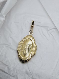 This is a very unique pendant---the shape is not often seen.  The geometric details at the edges really bring out the Art Deco style. The locket is quite large, at a little less than two inches long by 1 1/4 inch wide.  The total drop length with the clip is nearly three inches. The front of the locket has a hand carved floral design with a blank area for a monogram.  The back is polished gold-tone. The inside of the locket is clean and ready for portraits. I have included the clip so you can easily add the locket to your favorite chain. This piece is in excellent condition.   Free shipping in USA. Dog Clip Art, Dog Clip, Deco Jewelry, Unique Pendant, Art Deco Jewelry, Locket Necklace, Art Deco Style, Deco Style, Art Deco Fashion