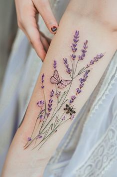 a woman's thigh with lavender flowers and butterflies on her left side ribcage