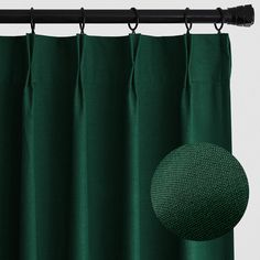 a green curtain with a round hole in the middle and black metal rod on top