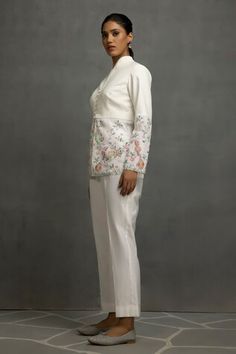 White top in linen base with floral and tabla instrumental embroidery in thread, sequins and beads. Paired with a pant. - Aza Fashions Elegant Pant Set With Intricate Embroidery For Spring, Elegant Spring Pant Set With Intricate Embroidery, Embroidered Pant Set For Summer Weddings, Spring Designer Sets With Pearl Embroidery, Spring Wedding Pant Set With Intricate Embroidery, Spring Festive Sets With Pearl Embroidery, Elegant Cotton Pant Set With Floral Embroidery, Embellished Pant Set For Wedding, Embellished Pant Set For Spring Wedding