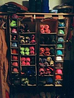 there is a large rack with many pairs of shoes