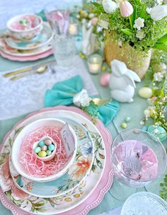 an easter table setting with pink and blue plates