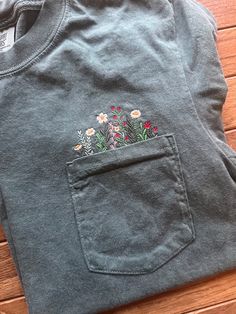 a pocketed t - shirt with flowers on it