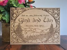 a wooden sign with the words gin no tin on it and flowers in a vase