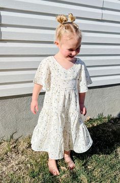 Introducing the Briggs Dress - the ultimate dreamy, flowy, and fabulous addition to your little's wardrobe! With its midi length, flowy sleeves, and v neckline, this dress is perfect for twirling around. But wait, there's more! The Briggs Dress also features a stunning floral pattern and tiered skirt detail, making it the perfect little girls dress. Dont forget to grab the adult version and match with your mini! *Relaxed fit* Material Content: Self: 100% Polyester // Lining: 100% Rayon Material Matching Mom, Flowy Sleeves, Mom Dress, Bring Happiness, Tiered Skirt, Girls Dress, Boutique Clothing, Midi Length