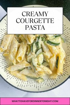 a white plate topped with pasta and cucumbers