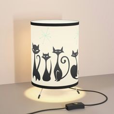 a lamp that has some cats on it