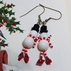 pair of snowman earrings with red and white beads