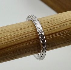 "This wedding band is made of 14k natural white gold. The Band is hand engraved and high polished. This wheat pattern style band is 2 mm wide, 1.8 mm tall. We can customize the curve to hug your ring. This band is available in either 14K yellow, white or pink gold. We can make it any size from 4 to 8 and you still be able to return it within the listed time frame. Ring sizing may add additional handling time. We love this ring because it represents the way jewelry should be made with craftsmansh Etched White Gold Jewelry For Anniversary, Engraved Platinum Rings For Gifts, Carved White Gold Engraved Ring For Formal Occasions, Formal Carved White Gold Engraved Ring, Etched White Gold Jewelry With Round Band, Adjustable Carved Rings For Anniversary, Formal Engraved White Gold Ring, Adjustable Carved Jewelry For Anniversary, Carved White Gold Rings For Formal Occasions