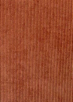 an orange striped fabric textured with thin vertical lines and horizontal stripes is seen in closeup