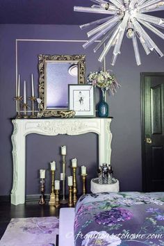 a bedroom with purple walls and a white fireplace