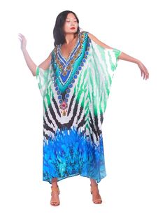 "Make a statement" "Elevate your wardrobe" "Bold print" "Luxurious" "Comfortable" "Elegant" "Sophisticated" "Perfect for any occasion" "Flair to your everyday look" "Multiple sizes" "Head-turning style" "Unbeatable comfort" Make a statement and elevate your wardrobe with the Turquoise Zebra Colt Shoulder! This kaftan boasts a bold print that exudes confidence and style. Crafted from luxurious poly satin, it offers unbeatable comfort that you won't find with any other piece in your wardrobe. The Elegant Printed Multicolor Kaftan, Elegant Multicolor Printed Kaftan, Elegant Printed Kaftan For Spring, Elegant Printed V-neck Kaftan, Elegant Green Kaftan For Vacation, Elegant Flowy Printed Kaftan, Elegant Printed Party Kaftan, Spring Party Printed Kaftan, Elegant Kaftan For Vacation Free Size