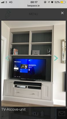 a flat screen tv sitting on top of a white entertainment center