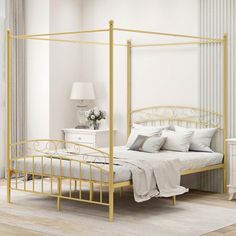 a white bedroom with a gold metal bed frame