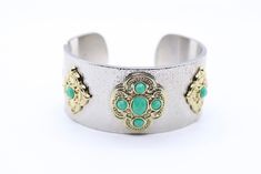 The Silver and Turquoise Cuff Bracelet combines the lustrous beauty of silver with the vibrant allure of turquoise stones, creating a striking accessory that captures a blend of elegance and Southwest-inspired charm. Its eye-catching design is sure to make a bold statement, adding a touch of natural beauty to your wrist. Turquoise Metal Bangle Cuff Bracelet, Elegant Green Metal Cuff Bracelet, Elegant Turquoise Cuff Bracelet, Turquoise Bracelet Cuff, Turquoise Cuff, Turquoise Stones, Silver Cuff Bracelet, Tennis Bracelet, Turquoise Stone