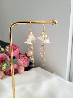 These elegant bell flower earrings are made with glass beads and 925 sterling silver. The dangle length is around 7cm/2.7". Each pair is lovingly handmade! 🎀 CARE INSTRUCTIONS 🎀 * Avoid getting your jewelry wet * Avoid perfumes or sprays * Store in a cool, dry place Elegant Flower Earrings With Dangling Beads For Gift, Elegant Flower-shaped Earrings With Dangling Beads, Dainty White Chandelier Earrings For Gift, Dainty White Chandelier Earrings As Gift, Elegant Adjustable Flower Earrings With Dangling Beads, White Flower Earrings With Dangling Beads For Gift, Lily Of The Valley Jewelry, Earrings Elegant, Jewelry Inspo