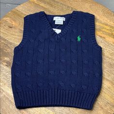 Polo Ralph Lauren Baby Knit Vest Size 12 Months New With Tags Color Blue With Green Embroidered Pony Fitted Blue Sweater Vest For Winter, Navy Cotton Sweater Vest For Winter, Navy Cotton Cable Knit Top, Navy Cable Knit Cotton Top, Classic Blue Cotton Sweater Vest, Classic Blue Winter Sweater Vest, Classic Blue Sweater Vest For Winter, Fitted Blue Knitted Sweater Vest, Blue Cotton Cable Knit Top