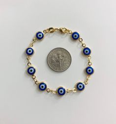 "18k gold filled dark blue evil eye bracelet for good luck, prosperity and protection. 5,25\" long for baby. pulsera de ojo azul oscuro de la buena suerte en 18k gold filled para prosperidad,buena suerte y poteccion. bebe 5,25\" largo." Spiritual Gold Bracelets With Evil Eye, Gold Evil Eye Bracelet Spiritual Style, 14k Gold Round Evil Eye Bracelets, Evil Eye Bracelet Hispanic, Blue 14k Gold Filled Bracelet Jewelry, Gold Plated Evil Eye Bracelet, 14k Gold Filled Blue Bracelet, Gold Spiritual Evil Eye Bracelet, Blue Evil Eye Bracelet For Good Luck