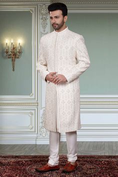 This Mens Sherwani (R14-S94) is the perfect attire for any groom with its beautifully crafted thread embroidery and stone embellishments. The intricate detailing adds a touch of elegance to this traditional garment. Its timeless design will make you stand out on your special day. Elegant Sherwani With Intricate Embroidery, Elegant Sherwani With Chikankari Embroidery In Traditional Drape, Elegant Sherwani With Chikankari Embroidery, Traditional Drape Sherwani With Naqshi For Reception, Elegant Sherwani With Dabka Work And Traditional Drape, Elegant Sherwani With Zari Work And Traditional Drape, Elegant Sherwani For Reception With Traditional Drape, Traditional Sherwani With Naqshi For Reception, Formal Kurta With Intricate Embroidery And Traditional Drape