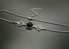 "Delicate victorian style choker featuring a genuine onyx stone sitting in an ornate bezel setting. The middle piece is set inbetween two beautifully detailed ornate connectors. The choker works fine on its own or stacked with another necklace. The chain is made of long lasting stainless steel and other components of high quality silver plated metal.  Stone:  12mm diameter Please choose your length in the drop down menu. Length = chain length including the clasp. Comes with an additional strong Elegant Black Choker Jewelry, Elegant Black Jewelry With Intricate Design, Elegant Antique Silver Metal Jewelry, Adjustable Oxidized Choker Jewelry, Victorian Style Adjustable Choker For Formal Occasions, Victorian Adjustable Choker For Formal Occasions, Adjustable Victorian Choker For Formal Occasions, Silver Gothic Gemstone Jewelry, Gothic Sterling Silver Choker Necklace