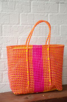 Be it to the local farmer’s market or a picnic at your favorite park or an exotic beach trip, our handwoven bags will help you carry all your essentials in style. These bags as very sturdy, easily washable and can be used as reusable grocery bags. Sure to make heads turn, this is colorful, handmade beauty is made using recycled plastic and helps you to eliminate single use plastic bags on your next grocery run. Pattern-----------Orange popsicle - A vibrant mix of orange & pink!Dimensions-------- Handwoven Bag, Exotic Beaches, Basket Tote, Stylish Storage Solutions, Handmade Beauty Products, Handmade Wire, Market Tote, Wire Baskets, Reusable Grocery Bags