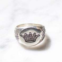 One of our new favorites, this sterling silver ring has an eclectic vibe that is special with an intricate royal crown and rising sun design. Available in both Men's and Women's size. Available in Brass https://etsy.me/2YsTLHR Ring Size Available in all sizes. Please be sure to find your exact ring size for the finger you want before ordering. See image chart above or you can use the chart on my website as a guide - https://jewelrylab.co/pages/ring-sizing-tips Every piece is handcrafted in Bali Classic Silver Crown Rings, Classic Silver Crown Shaped Rings, Classic Silver Rings With Crown Design, Classic Sterling Silver Rings With Crown Design, Silver Jewelry With Structured Crown Design, Sun Engraving, Sun Crown, Silver Pinky Ring, Ring Crown