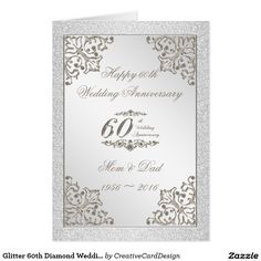 an elegant 60th wedding anniversary card with silver glitter and white flowers on the front,