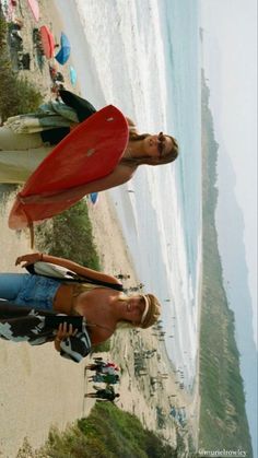 two women standing next to each other on the beach