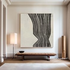 an abstract painting hangs on the wall above a bench and lamp in a living room