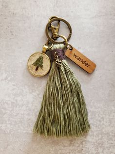 a tasseled keychain with a tree on it