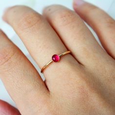 A simple 14k gold-filled or sterling silver band encrusted with your choice of birthstone Ruby gemstone in the center! ∙ Gift Ready in a jewelry box! ∙ Handmade in Vancouver, Canada.  ∙ 100% 14k Gold Fill or Sterling Silver ∙ Rings Sold Individually Please note: All stones due to its nature will vary in colour, flash and hue! --------------------------------- M E A S U R E M E N T :  Width: 1.25mm  Gemstone: 4mm  Size: Optional (US measurement) If your ring size is not specified as an option, pl 14k Gold Filled Gemstone Rings For Gift, 14k Gold Filled Stackable Rings As Gift, Simple Design Gold Stackable Rings As Gift, Adjustable Ruby Birthstone Ring In Fine Jewelry Style, Adjustable Ruby Birthstone Ring, Fine Jewelry, Simple 14k Gold Filled Round Rings, 14k Gold Filled Rings For Gift, Everyday Stackable Birthstone Rings, 14k Gold Filled Birthstone Ring