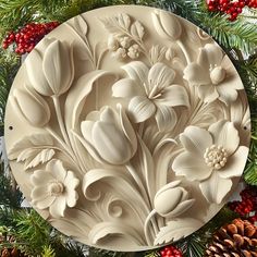 a christmas wreath with white flowers and pine cones