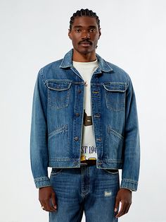 The Wrangler x PacSun Classic Denim Trucker Jacket blends timeless design with rugged durability. Made from rigid denim fabric, it features a classic collar, snap-flap chest pockets with a PacSun woven label, welt pockets at the hips, western-inspired stitching, a button-down front closure, and a relaxed fit. Pacsun Mens, Trucker Jacket, Denim Fabric, Pacsun, Outerwear Jackets, Vest Jacket, Mens Jackets, Timeless Design, Denim Jacket