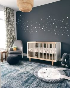 a baby's room with stars painted on the wall