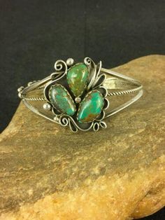 Masha Indian Native American Jewelry -On Route 66 - Albuquerque, New Mexico U.S.A Item Specifics           * Stone : Turquoise * Size : 6.5" * Gap : 1.20" * Top Measurements : 1.5" * Color : Green * Artisan : Elizabeth Platero * SKU : 8845 * Free gift with Purchases (Till Stocks Last) Genuine Sterling Silver Jewelry This beautiful Bracelet is made from all 925 Sterling Silver. These pieces are painstakingly handmade by the artist creating the perfect balance of color and shine. Whether you are just starting out or are a serious collector you will not be disappointed with this work of art. Authenticity you can Trust We have been in this industry since 1972, all our Jewelry is Authentic Artisan Handcrafted Sterling Silver. It is Designed, Manufactured, Finished, Polished, and Assembled in th New Mexico Usa, Turquoise Jewelry Native American, Albuquerque New Mexico, Native American Artists, Top Measurements, Navajo Turquoise, Bracelet Sterling Silver, American Jewelry, Native American Jewelry