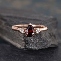 "Three Stone Garnet Engagement Ring Pear Shaped Rose Gold 3 Stone Bridal Diamond Women Anniversary Gift Drop Tear Wedding Rainbow ITEM INFORMATION Metal Type - Solid 14k Rose Gold Band Width - (approx.. 1.5mm) Center Stone - 5*7mm Natural Garnet, Pear Shaped Side Stone - Natural Diamond Weight - 0.12ct Clarity -SI Color - H **Stone Replacement** Available with any other gemstones, please feel free to contact me for a quote. **Metal Type** Available in 14K or 18K yellow gold, white gold, and rose Wedding Teardrop Three Stone Jewelry, Wedding Teardrop Three-stone Jewelry, Rose Gold Three Stone Wedding Ring, Wedding Rainbow, Engagement Ring Pear Shaped, Ring Pear Shaped, Engagement Ring Pear, Garnet Engagement Ring, Pear Shaped Engagement Rings