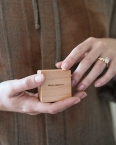 a woman holding a wooden box in her hands