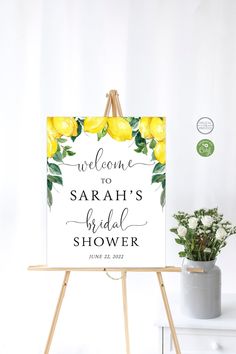 a welcome sign for the bride and groom on an easel next to a potted plant