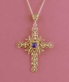 Looking for a meaningful and elegant piece of jewelry? Our handmade gold-plated solid silver filigree art cross pendant featuring a beautiful Amethyst gemstone is the perfect option. The cross is a Christian religious symbol that represents faith, good fortune, and protection. Our expert artisans have crafted the filigree art details inspired by nature, making each piece unique and special. The Amethyst gemstone is 6.00mm double-side faceted, checkerboard round-cut, adding a touch of luxury to t Crucifix Necklace With Intricate Design For Gifts, Intricate Crucifix Necklace As A Gift, Intricate Crucifix Necklace For Gift, Byzantine Cross Pendant Necklace For Gift, Spiritual Birthstone Cross Pendant Jewelry, Byzantine Cross Pendant Necklace As Gift, Byzantine Style Cross Pendant Necklace For Gift, Byzantine Style Cross Pendant Necklace As Gift, Gold Cross Gemstone Jewelry