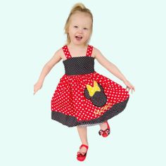 Get ready for a stylish Minnie Mouse birthday outfit! This adorable Minnie Mouse dress is perfect for your little one's special day. Made from a comfortable red and white polka dot cotton fabric, this dress features a Minnie Mouse embroider applique. You can even add your child's name and age if you like.Let your little one twirl and feel like a princess with the gathered fabric skirt. The bodice of the dress is fully lined in cotton fabric for extra comfort. Dressing up is made easy with the bu Playful Minnie Mouse Summer Dress, Fun Red Birthday Dress, Minnie Mouse Fitted Sleeveless Dress, Minnie Mouse Sleeveless Fitted Dress, Playful Minnie Mouse Fitted Dress, Red Minnie Mouse Party Dress, Playful Fitted Minnie Mouse Dress, Playful Minnie Mouse Party Dress, Cute Polka Dot Dress For Birthday