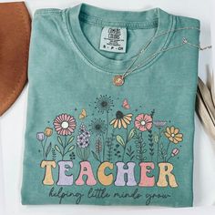 Comfort Colors Teacher Shirt, Teacher Wildflowers shirt, Teacher Life, Teach Tshirt, New Teacher Gift, Teacher Appreciation Gift, Fall Teach ☀️Popular Comfort Color 1717 tshirts ☀️Preshrunk, soft-washed, garment-dyed fabric ☀️Sizes: S-4X size up for an oversized tshirt fit. great for small business owners bridal parties  birthday shirts spring outfit nature lovers Christmas gifts Care instructions: Machine wash cold inside out. Dry on low.  Shipping: Items will ship within 1-5 business days. Dou Cute Printed Green T-shirt, Cute Green Printed T-shirt, Green Long Sleeve T-shirt With Floral Print, Green Shirt With Text Print For Spring, Cute T-shirt For Teacher Appreciation In Spring, Teach Tshirt, Shirt Spring Outfit, New Teacher Gift, New Teacher Gifts