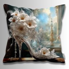 a pillow with white flowers and high heel shoes on it's side, in front of a window