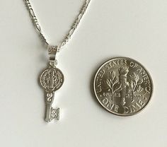 "925 STERLING SILVER SAINT BENEDICT KEY NECKLACE . 20\" LONG FÍGARO CHAIN. FOR GOOD LUCK ,PROSPERITY AND PROTECTION. PENDANT SIZE 22 mm X 8 mm CADENA DE 925 PLATA ESTERLINA SAN BENITO LLAVE. CADENA 20\" LARGO FIGARO. PARA BUENA SUERTE ,PROSPERIDAD Y PROTECCIÓN... TAMAÑO DEL DIJE : 22 mm X 8 mm" Silver Key Pendant Jewelry, Silver Pendant Necklace With Two Keys, Silver Key Pendant Necklace, Personalized Silver Jewelry For Good Luck, Silver Necklace With Two Keys For Gift, Silver Key Necklace For Gift, Good Luck Silver Engraved Charm Necklaces, Silver Engraved Charm Necklace For Good Luck, Good Luck Silver Engraved Charm Necklace