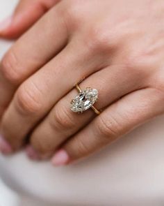 a woman's hand with a diamond ring on it